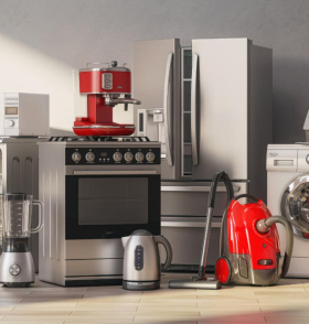 A group of home appliances: a stainless steel refrigerator and oven, red espresso machine, silver kettle, red vacuum cleaner, white washing machine, and iron.