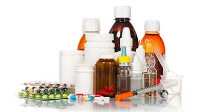 Assorted medications: pill bottles, liquid medicine, syringe, and loose pills.