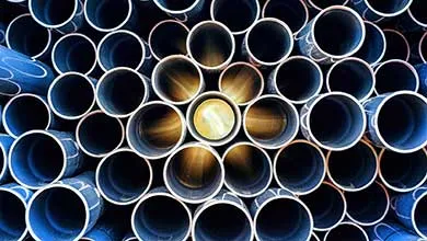 Stacked circular tubes viewed from the front, with one illuminated center tube highlighting precision material flow.