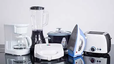 Collection of household appliances, including a coffee maker, blender, toaster, iron, and slow cooker, arranged on a reflective surface.