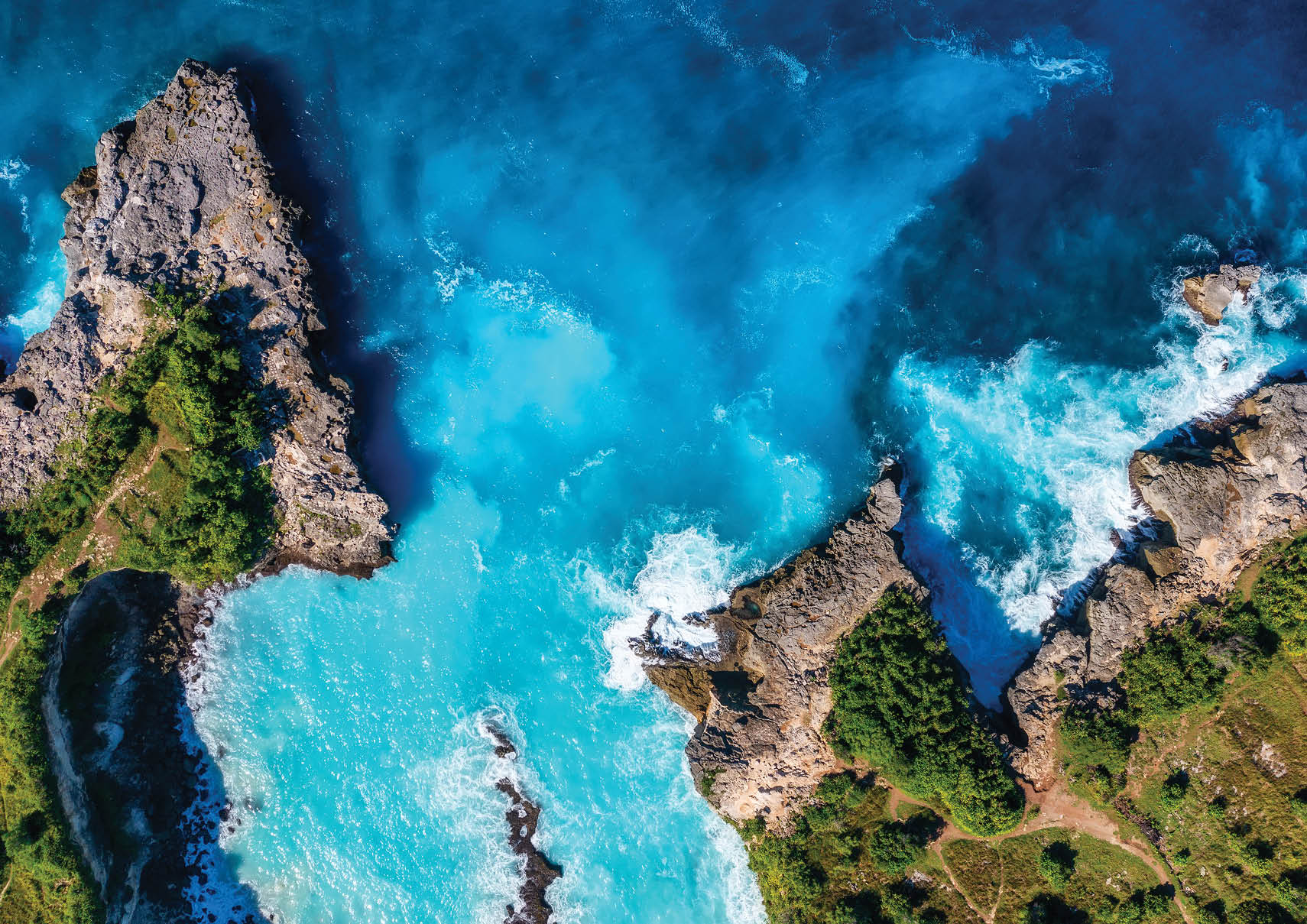 Waves and rocks as a background from top view. Blue water background from top view. Summer seascape from air. Bali island, Indonesia. 